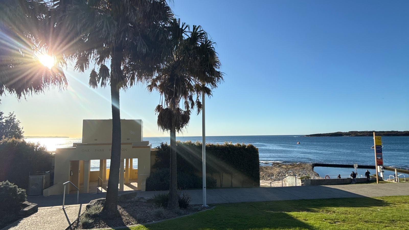 Morning sun over Oak Park Pavilion and the Sydney coast, representing personal time returned by a lighter business workflow.